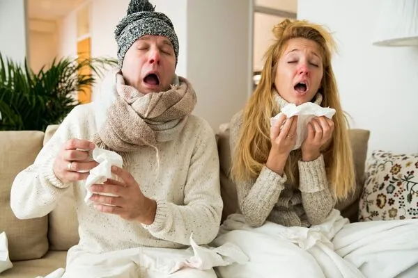 Sick Couple at Home Using Cold Medicine Image