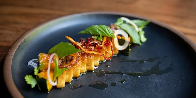 Uchi Austin's elegant dining area with sushi on plates