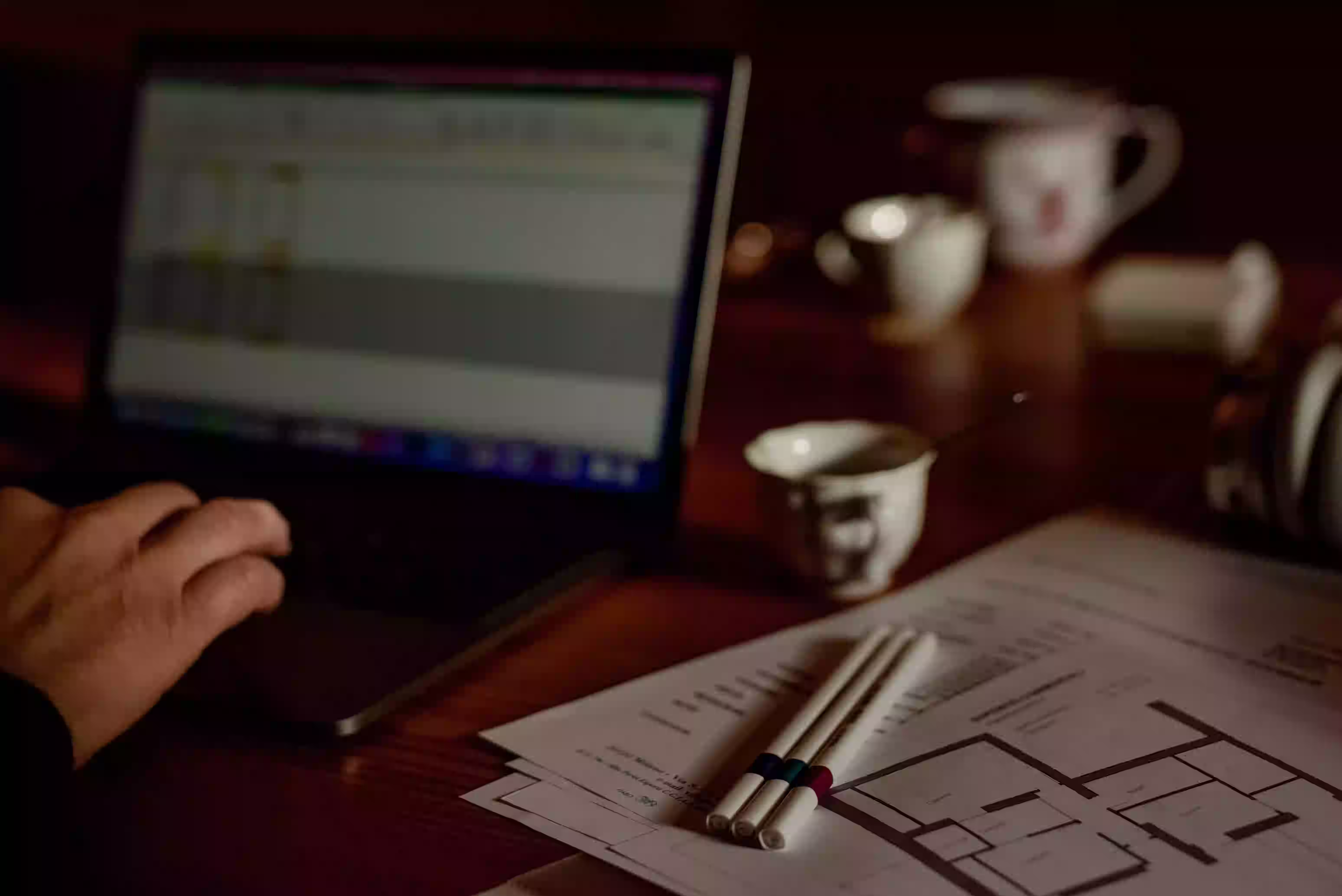 Contractor reviewing job-level profit and loss reports at a desk