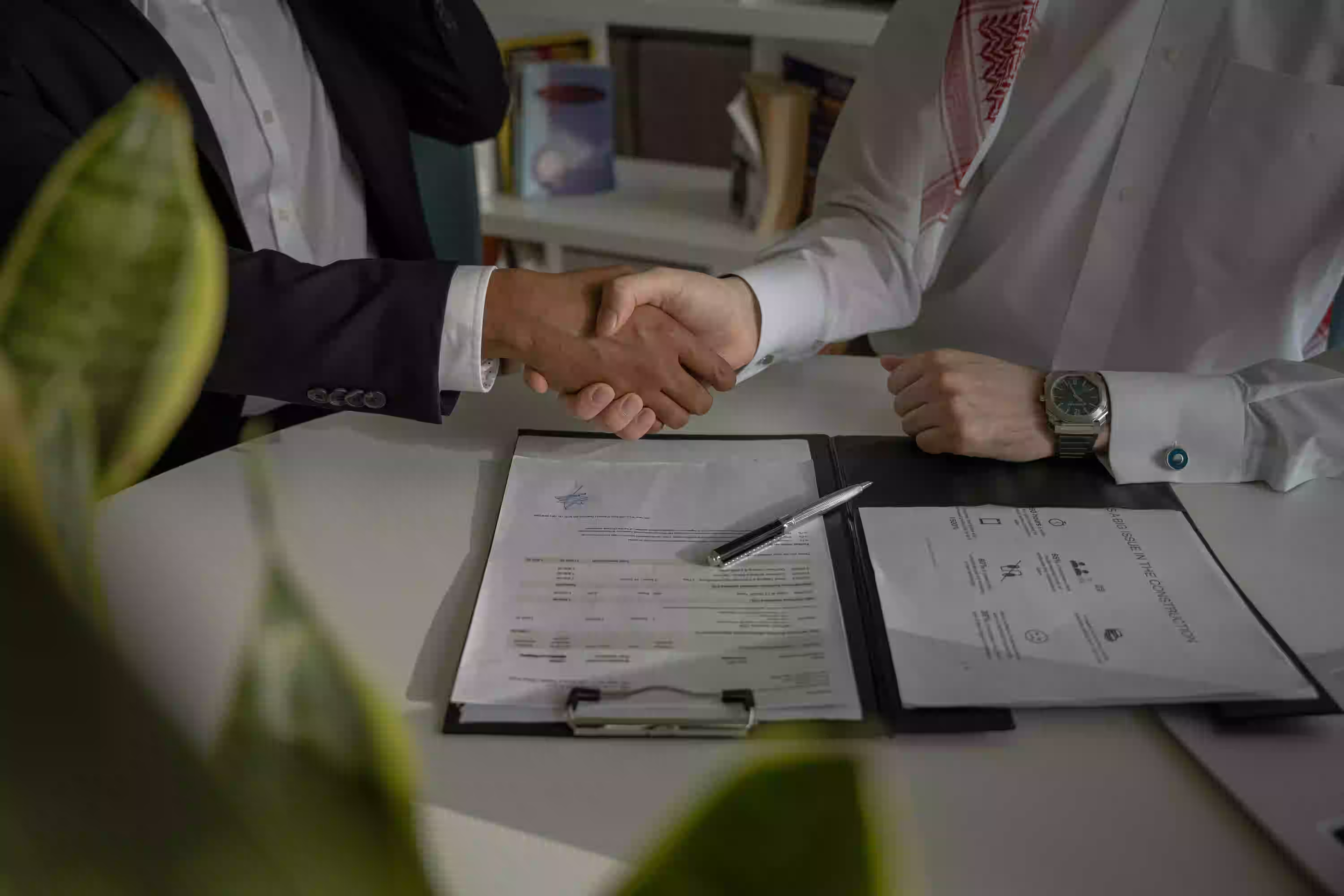 Contractor and surety agent reviewing bonding documents