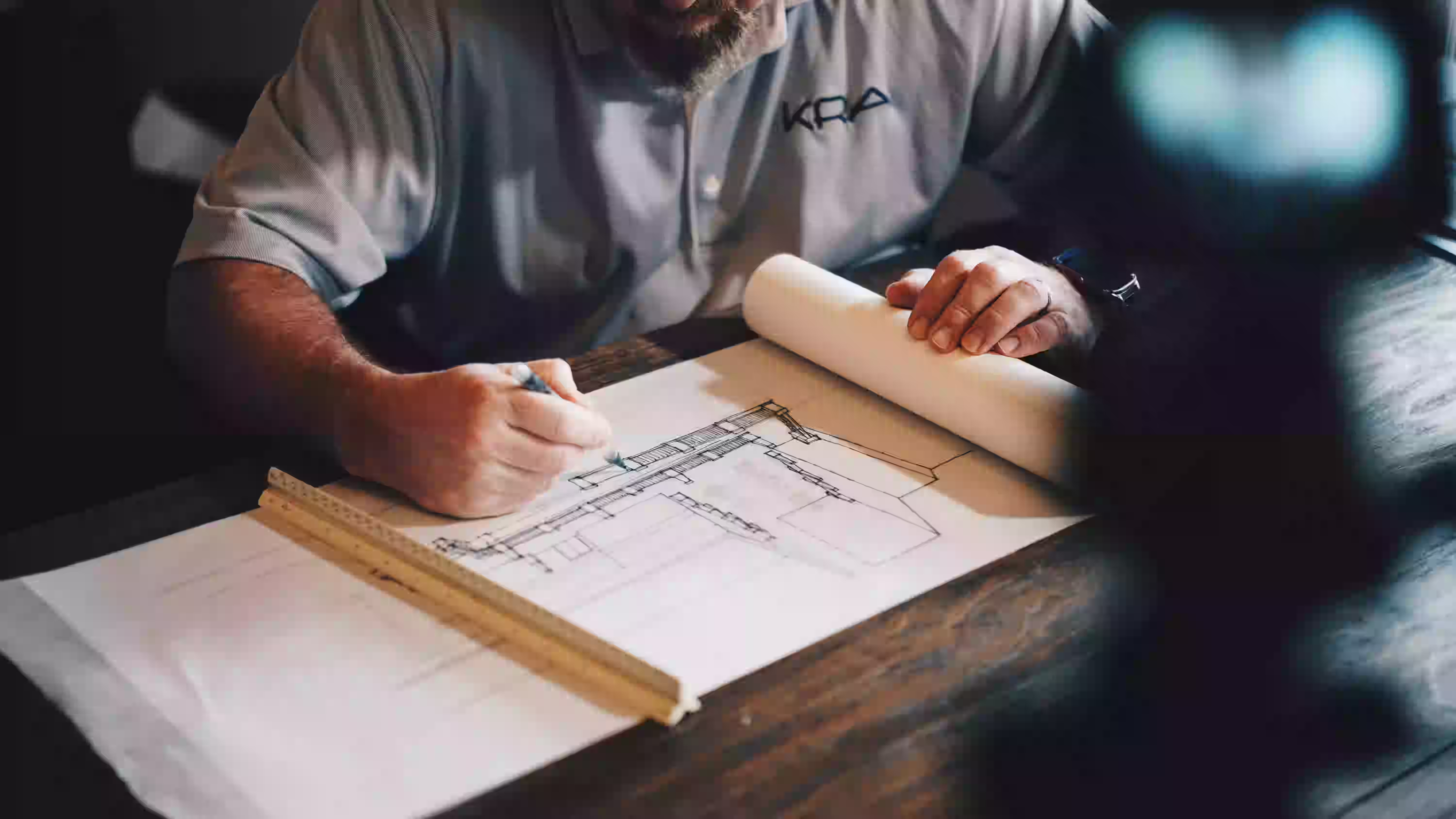 Contractor reviewing blueprints at table
