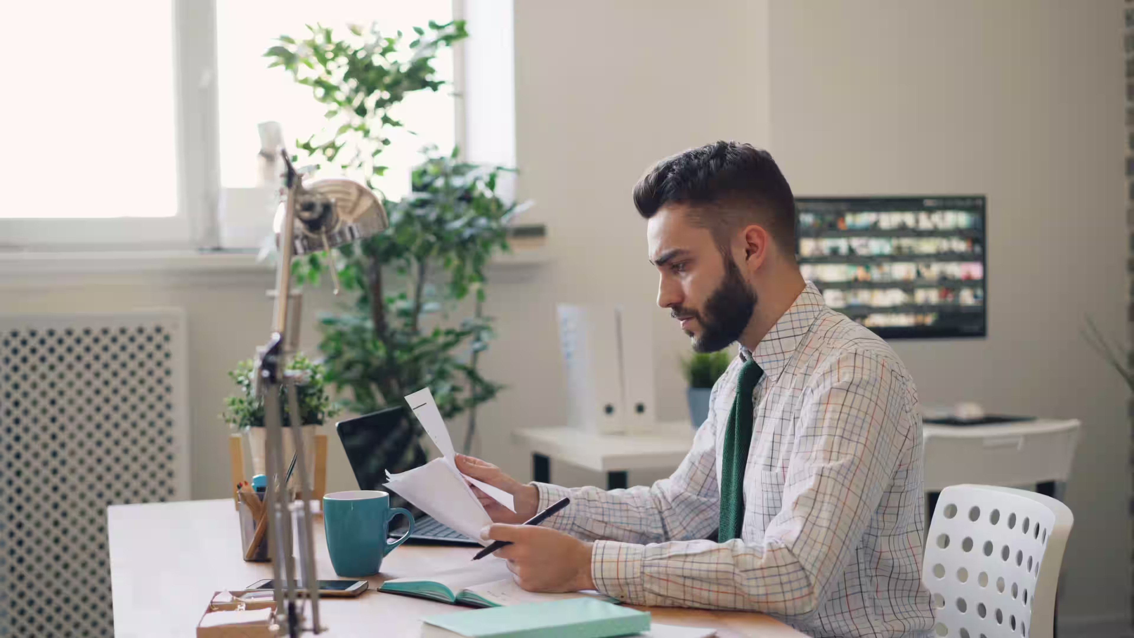 Contractor reviewing quarterly tax documents at a work desk