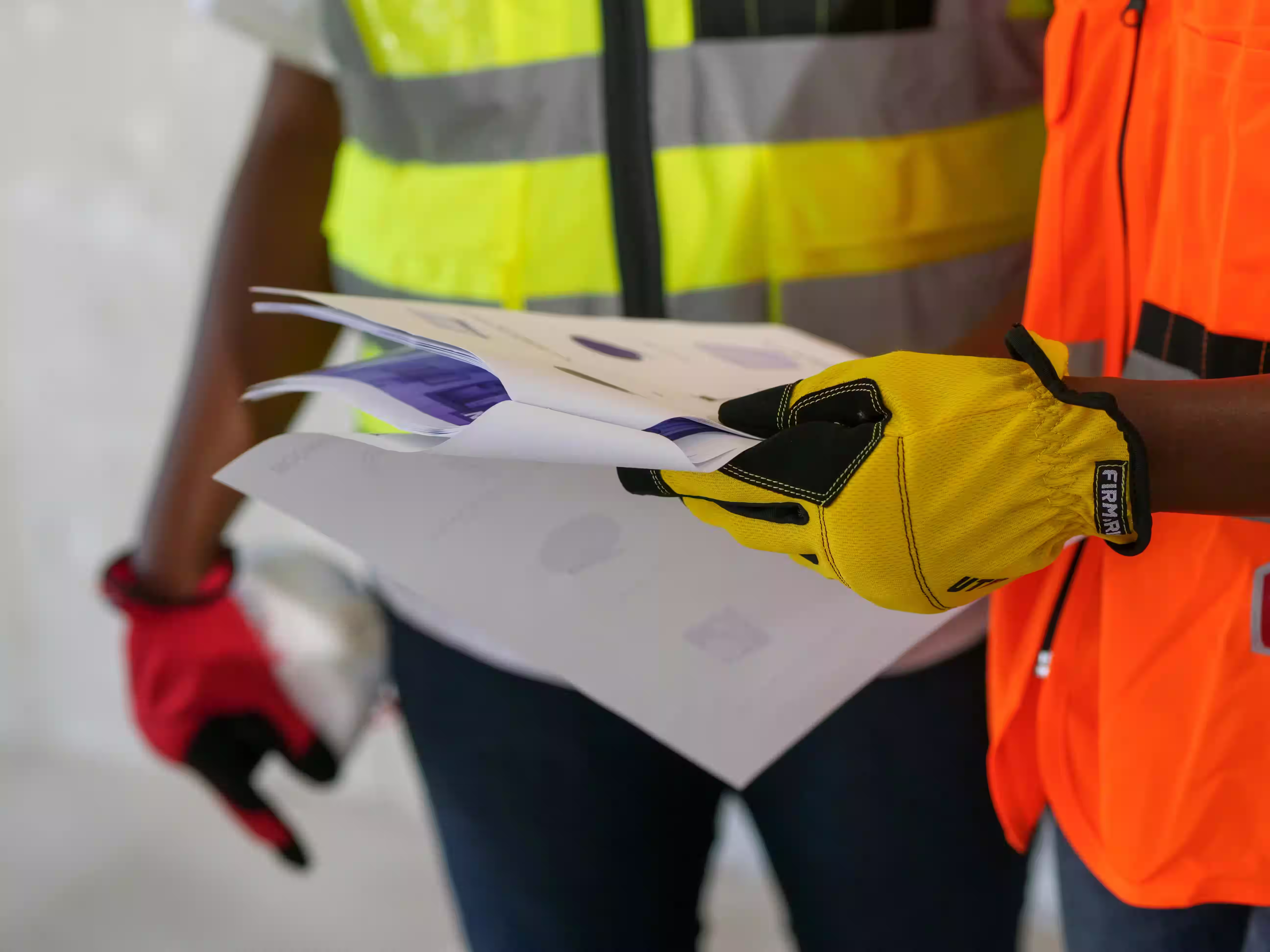 General contractor reviewing unpaid invoice documents on a job site