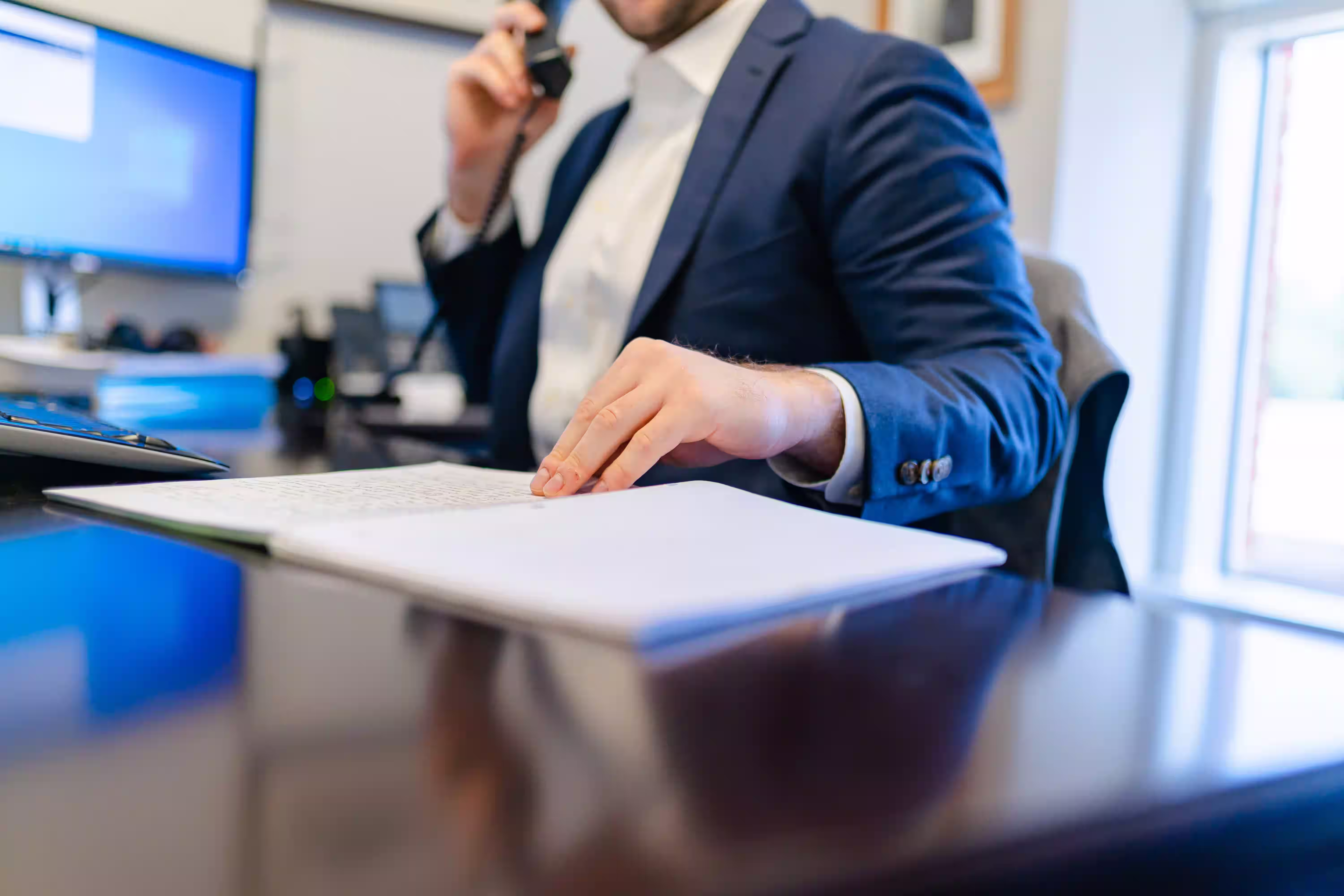 Construction company accountant reviewing financial reports at an office desk