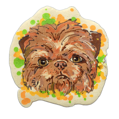 A close-up portrait of a small, shaggy brown dog's face centered on a cream-colored pancake cut to follow the rough outline of the subject's head and fur, surrounded by scattered circular spots in yellow, orange, and green batter. The portrait uses bold dark brown outlines with layered brown, rust,…