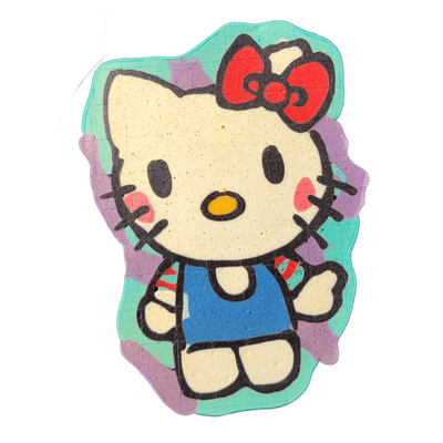 A cartoon cat figure with a round white head, small oval yellow nose, black dot eyes, pink cheek markings, and a large red bow on the upper right of the head, wearing a blue sleeveless top and shown in a seated frontal pose with arms slightly raised; the figure is set against an irregular blob-shap…