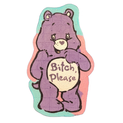 Pancake art of a cartoon bear standing upright with a rounded belly panel containing the text 'Bitch, Please' in stylized lettering; the bear has small rounded ears, wide eyes with lashes, a heart-shaped nose mark, and an open-mouthed expression. Rendered with bold black outlines and filled in purp…