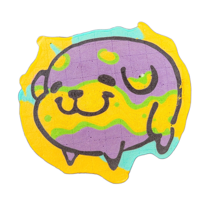 Pancake art depicting Poffridge, a Shiba Inu-shaped sentient poffertje character from the JoP cast, shown as a rounded cartoon face with small nose, wide mouth, and stubby ear-like protrusions at the top, set against a roughly circular blobby outer border with drip-like extensions along the bottom…