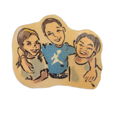 Pancake art depicting three children posed together, the child in the center wearing a blue shirt with a white graphic, flanked by two others who appear to be smiling or laughing, with one wearing a yellow headband on the left. Rendered with bold black outlines and watercolor-style batter fills in…