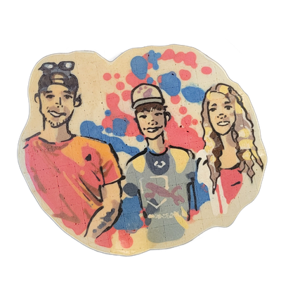 Pancake art portrait of three people identified as Brax and two adults (an aunt and uncle): a young man on the left with sunglasses pushed up on his head, facial stubble, and a red-orange shirt with his arms crossed; a younger male in the center wearing a forward-facing cap and a gray graphic shirt…