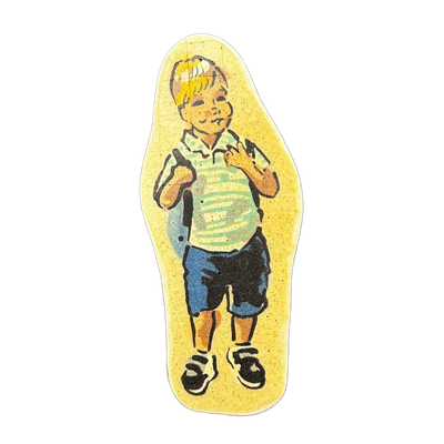 Pancake art depicting a young child standing upright, wearing a striped short-sleeve shirt in green and white, blue shorts, and black-and-white shoes, with blonde hair and visible freckles, carrying what appears to be a backpack with straps visible over both shoulders.