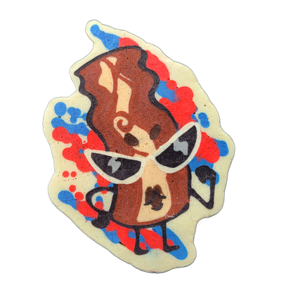 Pancake art depicting Sugar, a bacon-shaped character from the JoP cast, rendered in an upright standing pose with arms bent outward, wearing large white cateye sunglasses with dark lenses, surrounded by splashes of red and blue batter that form a loose, energetic background halo around her figure.…