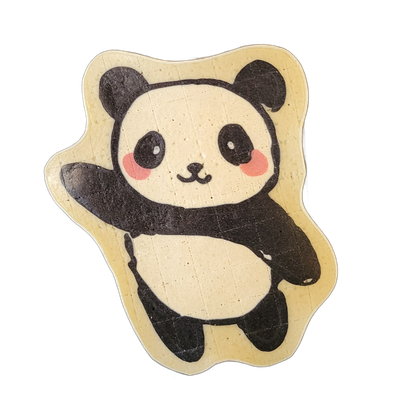Pancake art depicting a cartoon-style panda bear in a rounded, upright pose with one arm raised and the other extended, black oval eye patches, round pink cheek markings, small black nose and mouth, black ears, black limbs, and a light-colored torso and face, set against a pale yellow-toned border…