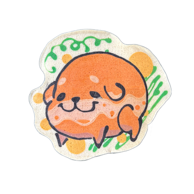 Pancake art of Poffridge, a Shiba Inu rendered in the shape of a round poffertje, shown curled with small paws visible at the bottom, a blunt muzzle with a slight smile, and closed or squinting eyes outlined in bold black batter lines. Drawn by Wella in approximately 13 minutes, the piece uses oran…
