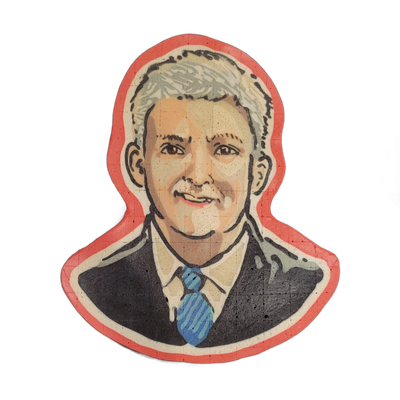 Pancake art portrait of a man named Walsh, depicted from the shoulders up, wearing a dark suit jacket, white dress shirt, and a blue diagonal-striped tie, with short gray-white hair and a slight smile; a red border ring frames the bust shape against the griddle surface. Rendered with bold black out…