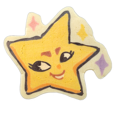 Pancake art of Charli, a star-shaped character from the JoP cast, depicted as a five-pointed yellow star with a cartoon face: one eye open with lash detail, one eye winking, rosy cheek marks, a small orange nose, and a smile showing teeth, surrounded by a cream-colored background border decorated w…