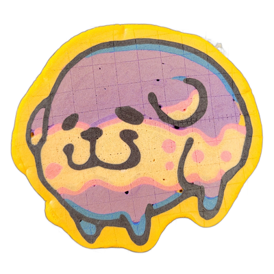 Pancake art depicting Poffridge, a Shiba Inu–shaped sentient poffertje character, shown as a rounded face with dark batter outlines forming closed curved eyes and a small nose, with a loose wavy line suggesting a mouth or drool drip along the bottom edge, and a curling accent mark above suggesting…