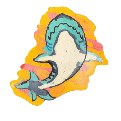 A shark drawn in pancake art, shown in a curved body position with its mouth open, teeth visible, and pectoral and tail fins extended; a smaller shark or fish shape appears near the lower left, partially behind the main figure.