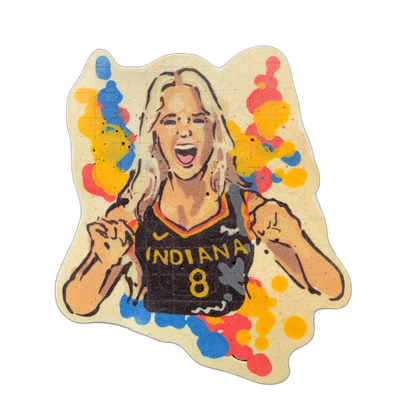Pancake art depicting Sophie Cunningham, shown from the waist up wearing a dark jersey reading 'INDIANA' with the number 8, mouth open wide and both fists raised near her sides in a celebratory pose, with long light-colored hair. The piece is rendered with bold dark outlines and warm skin-tone batt…