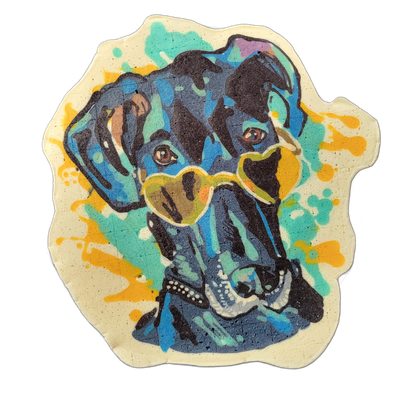Pancake art portrait of Zuzu the Great Dane, a dog depicted from the chest up with floppy ears, brown eyes, a broad muzzle with white dot highlights on the nose, and heart-shaped yellow-green tinted glasses resting on the snout. Rendered with bold black outlines and dense fill in blues and teals ac…