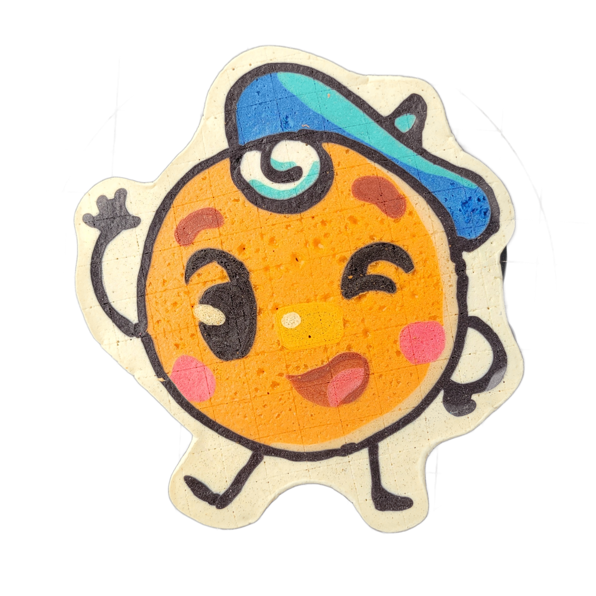 Pancake art depicting Jacques Floppes, a round soufflé-pancake character with a cartoon face featuring one wide open eye and one closed eye, pink circular cheeks, a small open mouth, and chocolate-chip-style spots on an orange-toned body, wearing a blue and teal cap tilted to one side with a teal s…