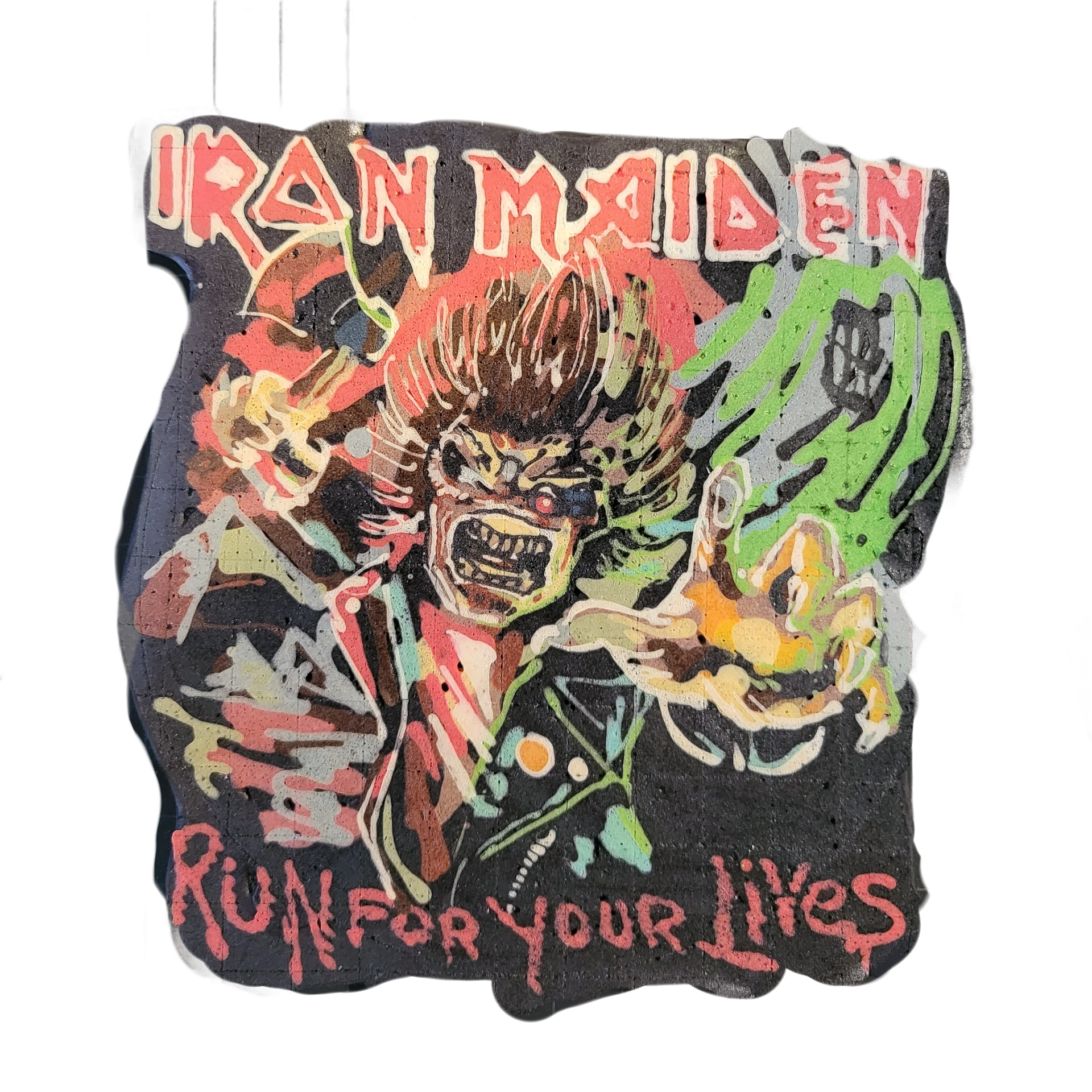 Pancake art depicting the text 'IRON MAIDEN' at the top and 'RUN FOR YOUR LIVES' at the bottom in jagged red lettering, surrounding a central figure with wild hair, an open-mouthed grimacing expression, red eyes, and outstretched hands with green energy-like swirls emanating from one hand, rendered…