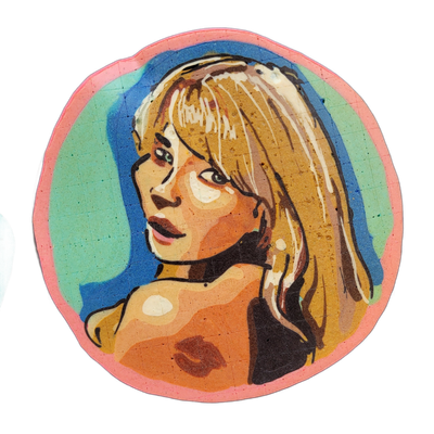 Pancake art depicting a portrait of a woman with long blonde hair falling past her shoulders, looking slightly to one side, with bare shoulders visible at the lower portion of the composition, set against a teal and blue background within a circular format bordered in pink. Rendered with bold dark…