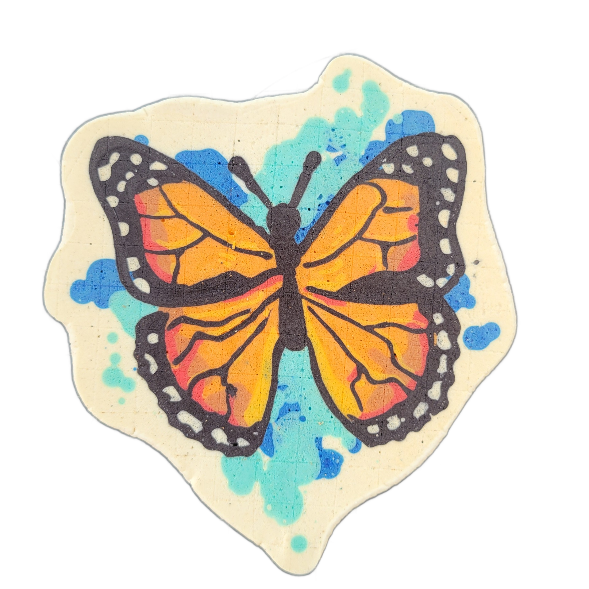 A monarch butterfly with wings spread open, rendered in orange, red-orange, and yellow, with bold black outlines, black veining across the wings, and white dot markings along the wing edges; a blue and teal paint-splatter pattern fills the cream-colored background behind the butterfly. The pancake…
