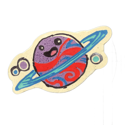 Saturnina, a JoP original character depicted as a cartoon planet with Saturn-style rings, a round purple body marked with swirling red and blue surface patterns, a wide open mouth with a pink tongue, and two round eyes; two small satellite circles flank the planet on either side, one purple and one…
