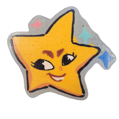 Pancake art depicting Charli, an original JoP character designed as a sentient star from Vincent van Gogh's The Starry Night: a five-pointed yellow-orange star with a cartoon face featuring two large black-outlined eyes with white highlights, rosy brown cheek marks, a small orange teardrop accent,…
