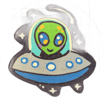 Pancake art depicting Trav, a green-skinned alien character with large blue eyes, yellow spots on the forehead, and a small smiling mouth, seated inside a gray and blue flying saucer with circular porthole details along its rim, set against a dark star-filled background with four-pointed star shape…