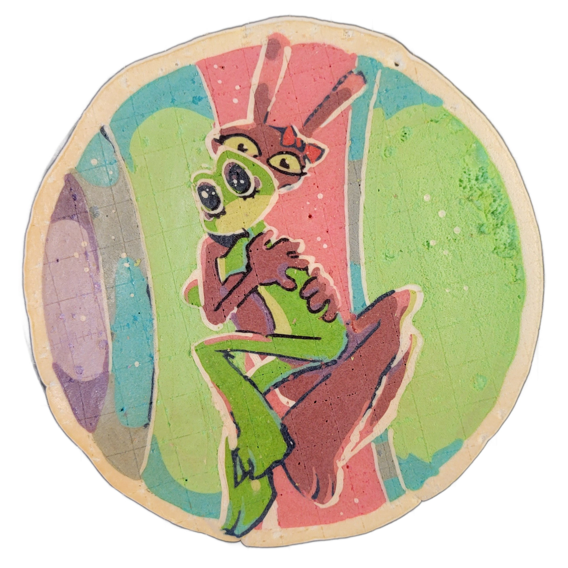 Pancake art depicting two cartoon characters named Jax and Ribbit: one is a green frog-like figure with large round eyes and a slender body, posed with limbs bent and hands raised near its face, and the other is a smaller pink-red creature with yellow eyes, small horns, and long upright ears, posit…