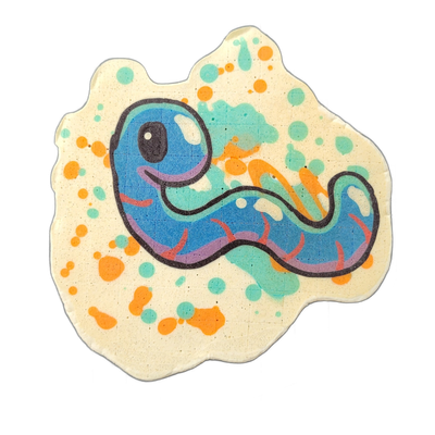 Pancake art of Hermie, a blue cartoon worm character with a large round head, one oversized dark eye with a highlight, a small open smile, and a segmented body that curves in an S-shape with short red leg-like appendages along the underside and a pointed tail end. Bold dark outlines define the figu…
