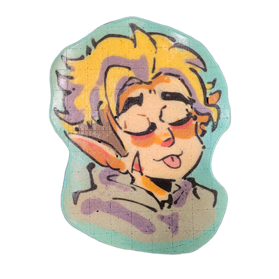 Pancake art of a character named Hunter, depicted from the shoulders up, with voluminous yellow hair accented with purple, pointed ears, rosy orange-tinted cheeks, heavy dark brows, half-closed eyes, and a tongue sticking out slightly from an open mouth, wearing a gray-purple collared top. The piec…