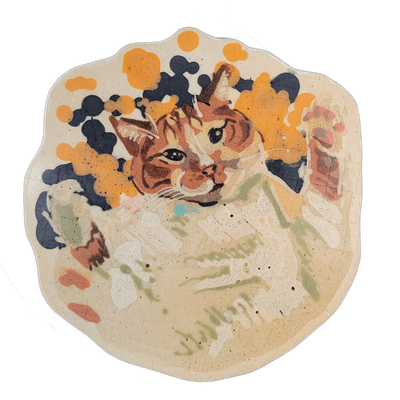 Pancake art depicting a tabby cat named Punky, shown from roughly the chest up, with orange and brown striped fur, white facial markings, a pink nose, and dark eyes, positioned against a dark navy-blue background with scattered orange spots and blobs. Rendered by Dan using fine dark brown outlines…
