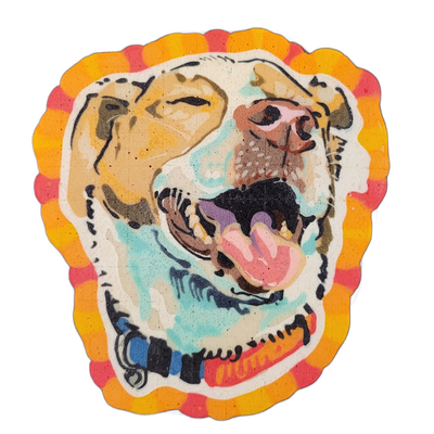 Pancake art portrait of a dog named Bradley, shown from the neck up, facing slightly right with mouth open wide, tongue visible, and eyes appearing nearly closed; the dog wears a collar with blue and orange elements. The piece uses bold black outlines with broad fill areas in tan, teal, pink, brown…
