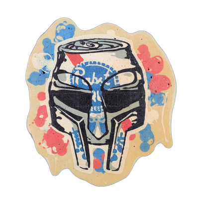 Pancake art depicting a beer can styled to look like a Pabst Blue Ribbon can, positioned as the top portion of a stylized mask with angular eye openings, a prominent nose bridge, and jaw-like lower extensions. Rendered with bold black outlines, flat fills of blue, red, gray, and cream-white batter,…