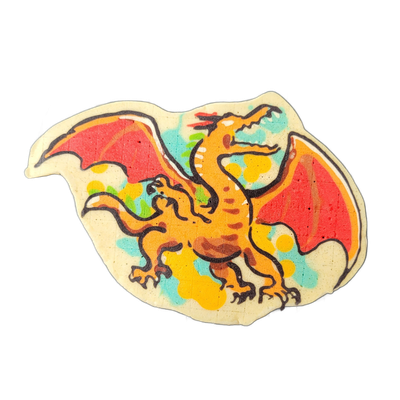A pancake art depiction of a four-legged dragon with two large bat-style wings spread wide, facing right, with clawed feet, a horned and open-jawed head, and a long curling tail; the body is orange with brown shading, and the wings are red-orange fading to red. Bold black outlines define the figure…