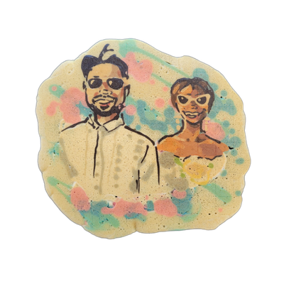 Pancake art depicting two people posed side by side against a background of pink and teal color splatters; the figure on the left wears sunglasses and a collared shirt, and the figure on the right wears an off-shoulder garment and holds what appears to be a bouquet of flowers. Rendered with bold bl…