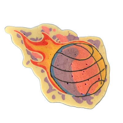 A flaming basketball rendered in pancake art, showing a round ball with curved seam lines trailing flames that extend to the left. The ball is filled with overlapping areas of coral pink and violet, outlined in dark batter, with a blue ring around the ball's edge; the flames transition from red at…