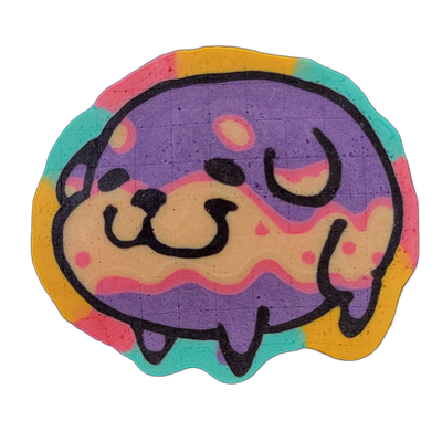 Pancake art depicting Poffridge, a Shiba Inu–shaped sentient poffertje from the JoP cast, shown as a rounded, slightly irregular disc form with a cartoon dog face centered on the left side and abstract drip and wave shapes extending across the body to the right. Bold black outlines define the face…