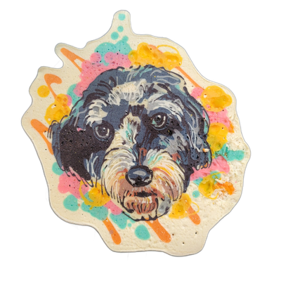 A pancake art portrait of a dog named Jojo, shown as a close-up face with dark gray and black fur, white facial markings around the muzzle and eyebrows, and brown coloring beneath the nose and chin. The portrait is rendered with fine black outlines and layered batter in dark gray, white, and warm b…