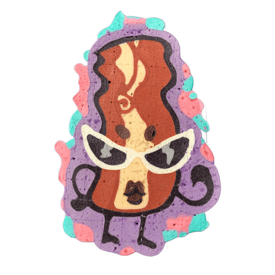 Pancake art depicting Sugar, an original JoP character designed as a strip of bacon wearing white cat-eye sunglasses, with a face featuring two dark eyes, a small nose, and an open mouth, framed by large, loose dark curls at the bottom and flowing wavy auburn and cream tones forming the body of the…