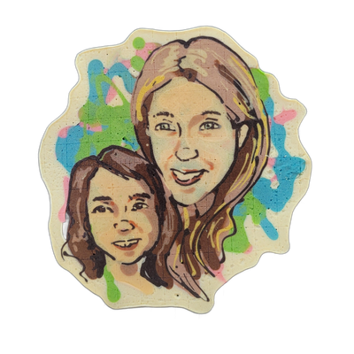 Pancake art depicting two female-presenting faces close together: a taller figure with long brown and blonde-highlighted hair and a headband or hair accessory at the top of the frame, and a shorter figure with shorter brown hair positioned in the lower left, both shown from approximately the neck u…