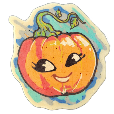 Pancake art of Charli, a JoP original character depicted as a cartoon pumpkin with a curved green stem and tendril, large stylized eyes with eyelashes, and a small smiling mouth showing teeth, set against a blue and teal background wash. Bold black outlines define the figure, with the pumpkin body…