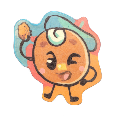 Pancake art depicting Jacques, a round-bodied cartoon character from the JoP cast, with a large circular head, one open eye and one closed eye in a winking expression, a small square nose, an open mouth showing a tongue, rosy cheek marks, a teal swirl on the forehead, a teal beret-like shape on top…