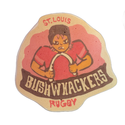Pancake art depicting a sticker-style sports logo reading 'ST. LOUIS BUSHWHACKERS RUGBY,' featuring a cartoon figure in a red jersey and brown helmet, holding a rugby ball, with an exaggerated scowling expression and bared teeth, set against a pink cloud-like background with a brown banner across t…