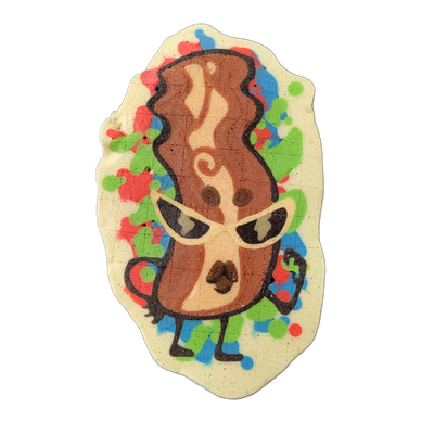 Pancake art depicting Sugar, a strip of bacon rendered as an upright anthropomorphic figure with cat-eye sunglasses, one arm raised with a small clenched fist, standing on two small feet, with a swirling lighter streak running vertically through the center of the brown bacon body. Bold dark outline…