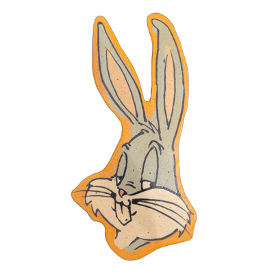 Pancake art depicting Bugs Bunny, the Warner Bros. cartoon rabbit, shown as a close-up head portrait with tall upright ears, half-lidded eyes, prominent whiskers, a small pink nose, and folded paws raised near the chin. Rendered with bold dark outlines and filled areas in muted gray-green, cream, a…
