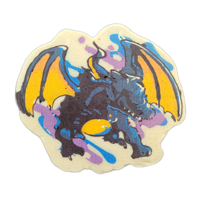 Pancake art depicting a dragon with spread bat-like wings, rendered in a mostly upright pose facing slightly to the right, with a long tail visible at the lower center. The image uses bold dark brown-black outlines filled with yellow-orange on the wings, dark brown-black on the body, and accents of…
